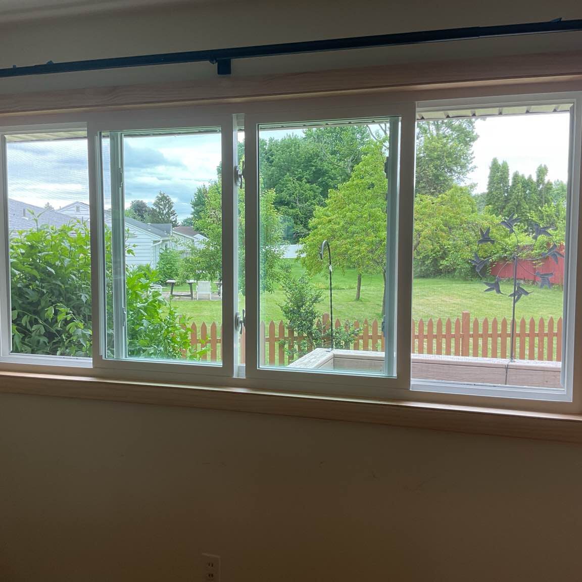 Energy-efficient double sliding windows with clear glass and sturdy frames, offering maximum light and easy access to fresh air.