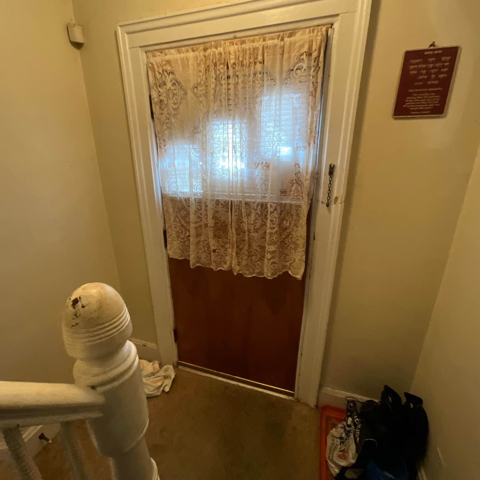 Outdated entry door in Utica, New York.