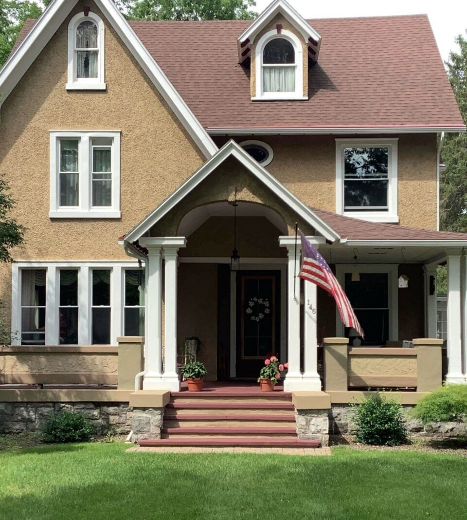 House with newly installed double hung windows finished in white.