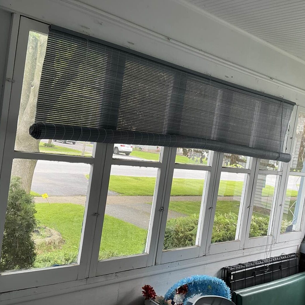 Outdated, single-pane windows with peeling paint on a historic home in Oneida, NY, prior to New York Sash replacement.