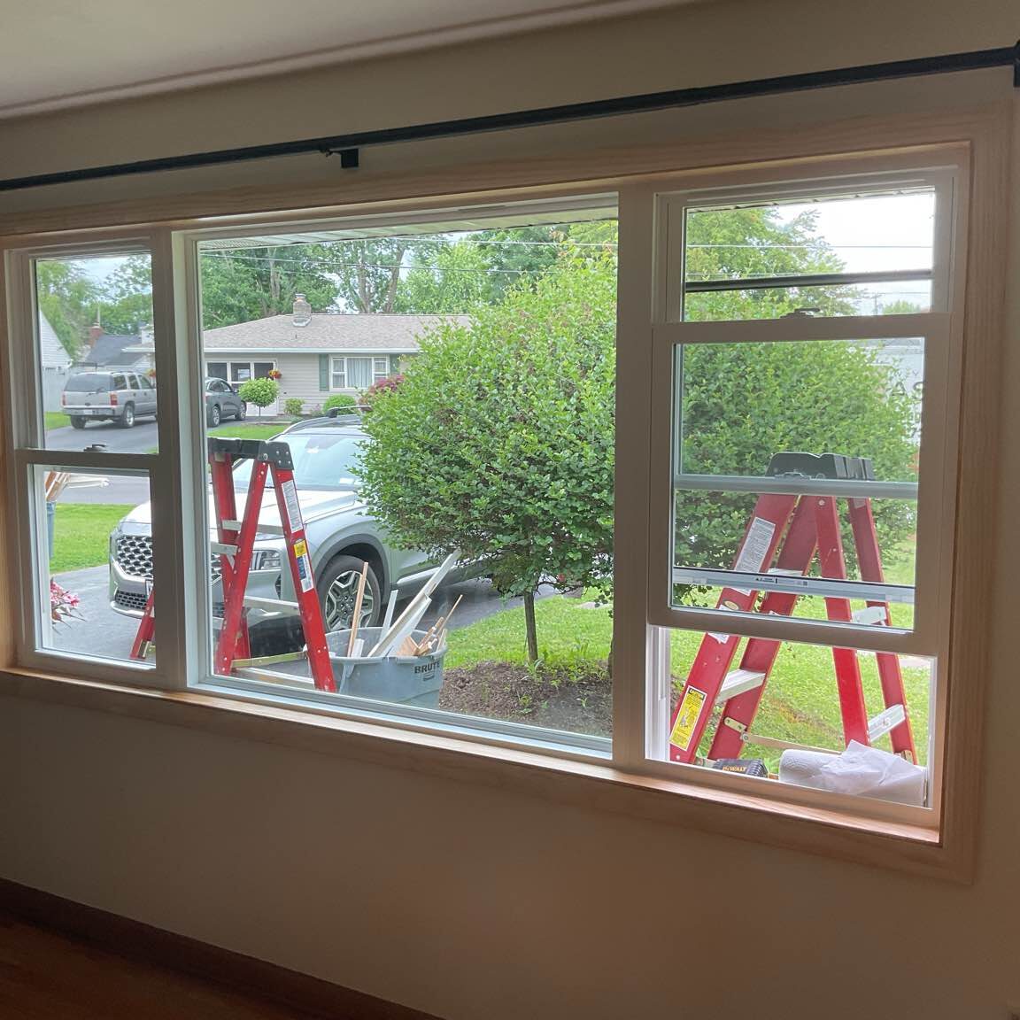 An expansive picture window paired with a versatile double-hung window, both newly installed, bringing abundant natural light and ventilation into a living space.